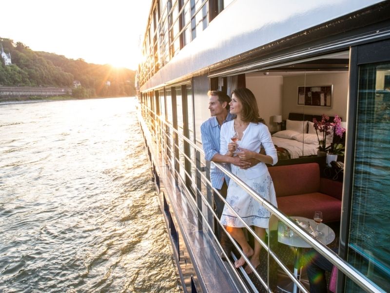 Avalon Waterways Panorama Suite interior view with 11 feet wall-to-wall window and bed facing the river view